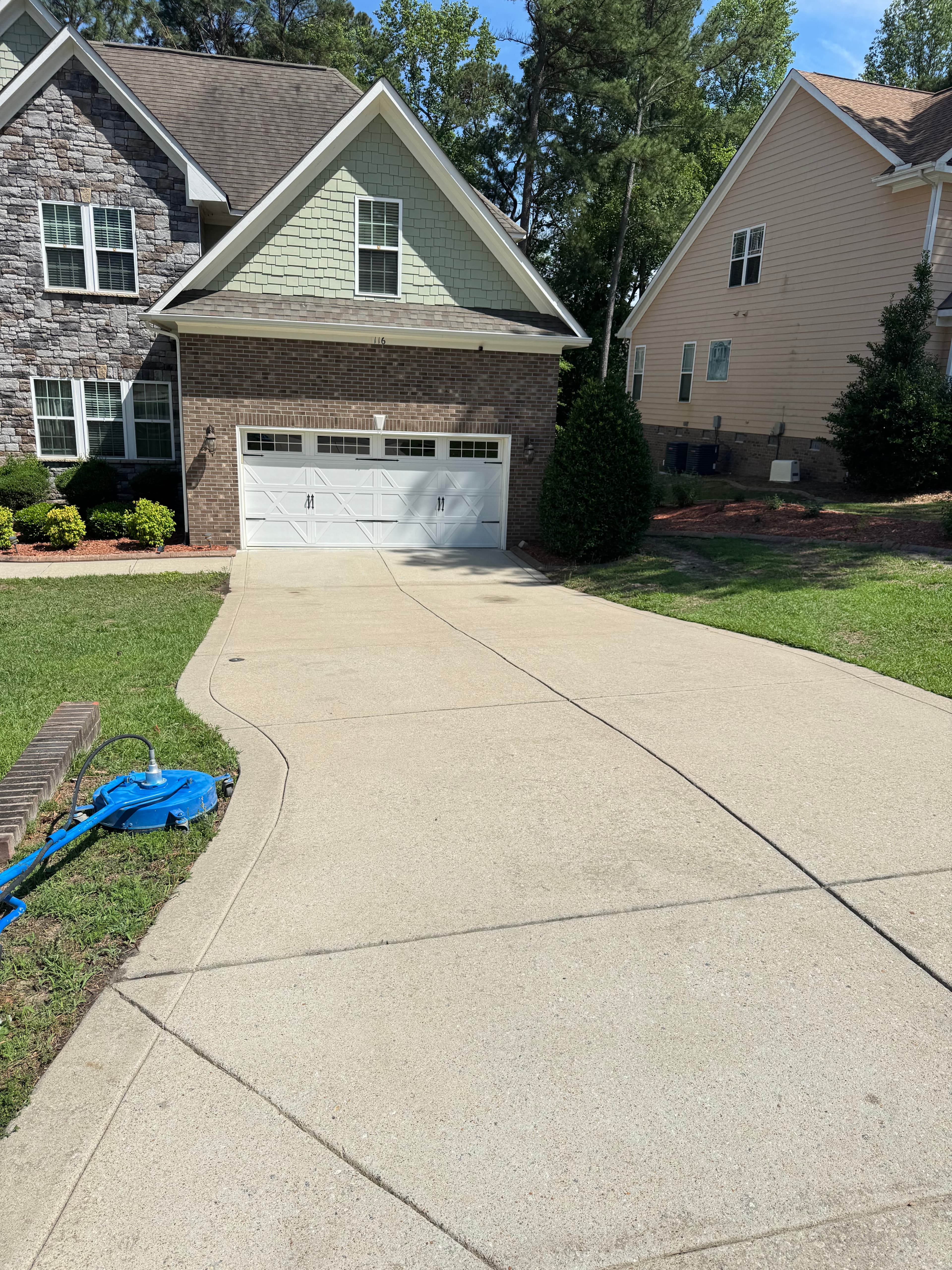 After driveway pressure washing by Max Pressure in Fayetteville NC — clean concrete driveway