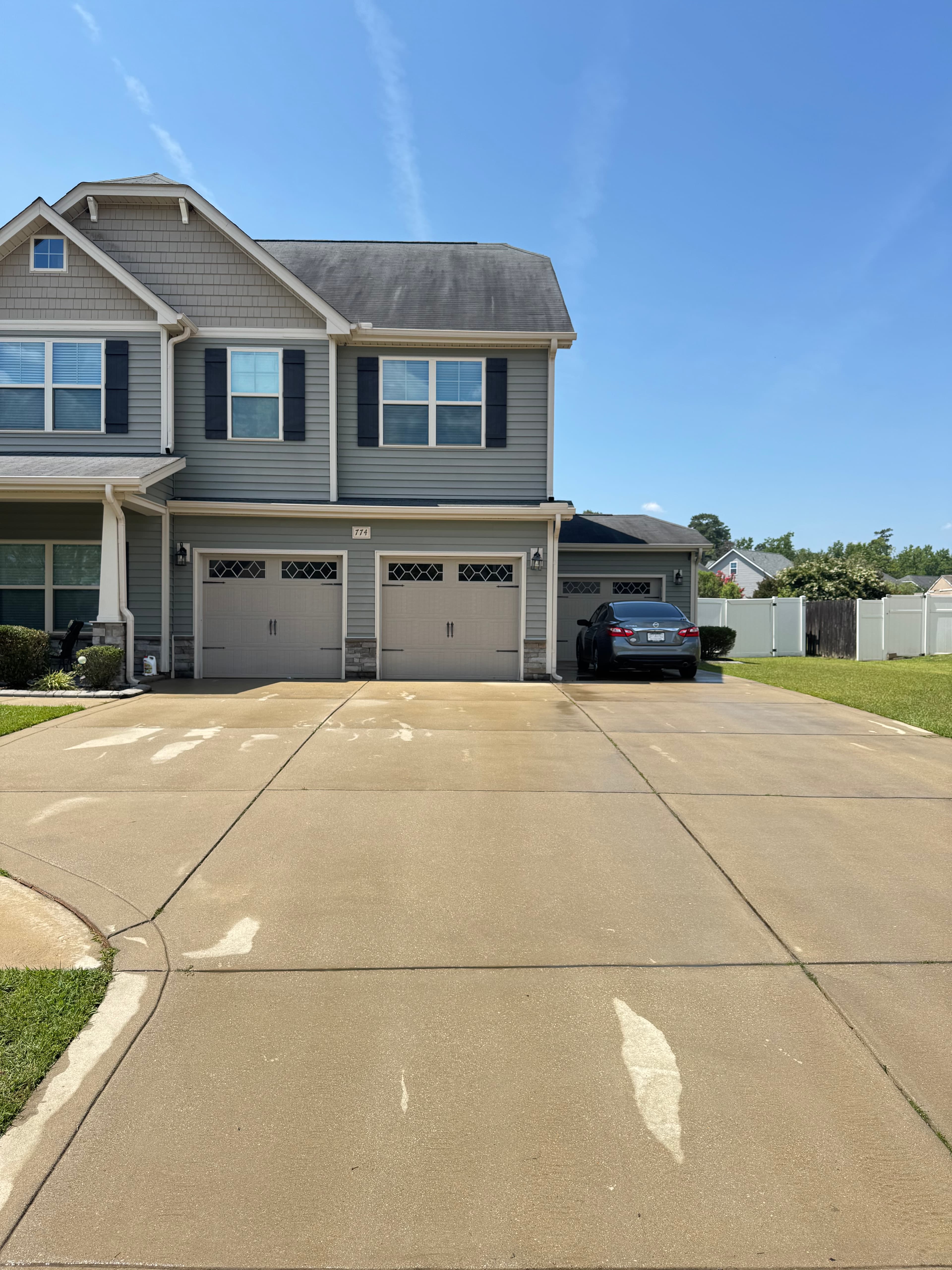 After driveway pressure washing by Max Pressure in Fayetteville NC — bright, clean concrete driveway