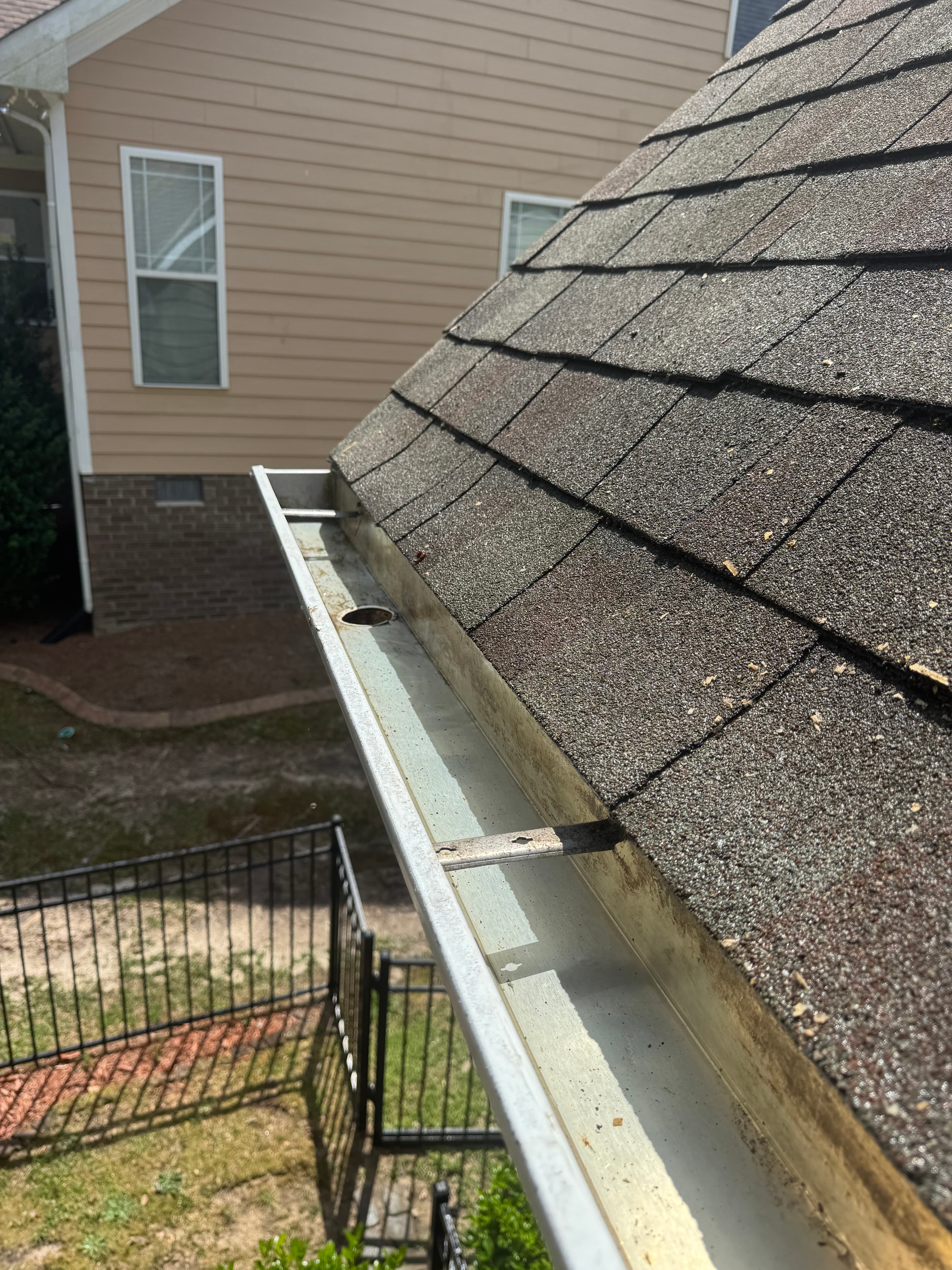 After gutter cleaning by Max Pressure in Fayetteville NC — clear gutters draining properly