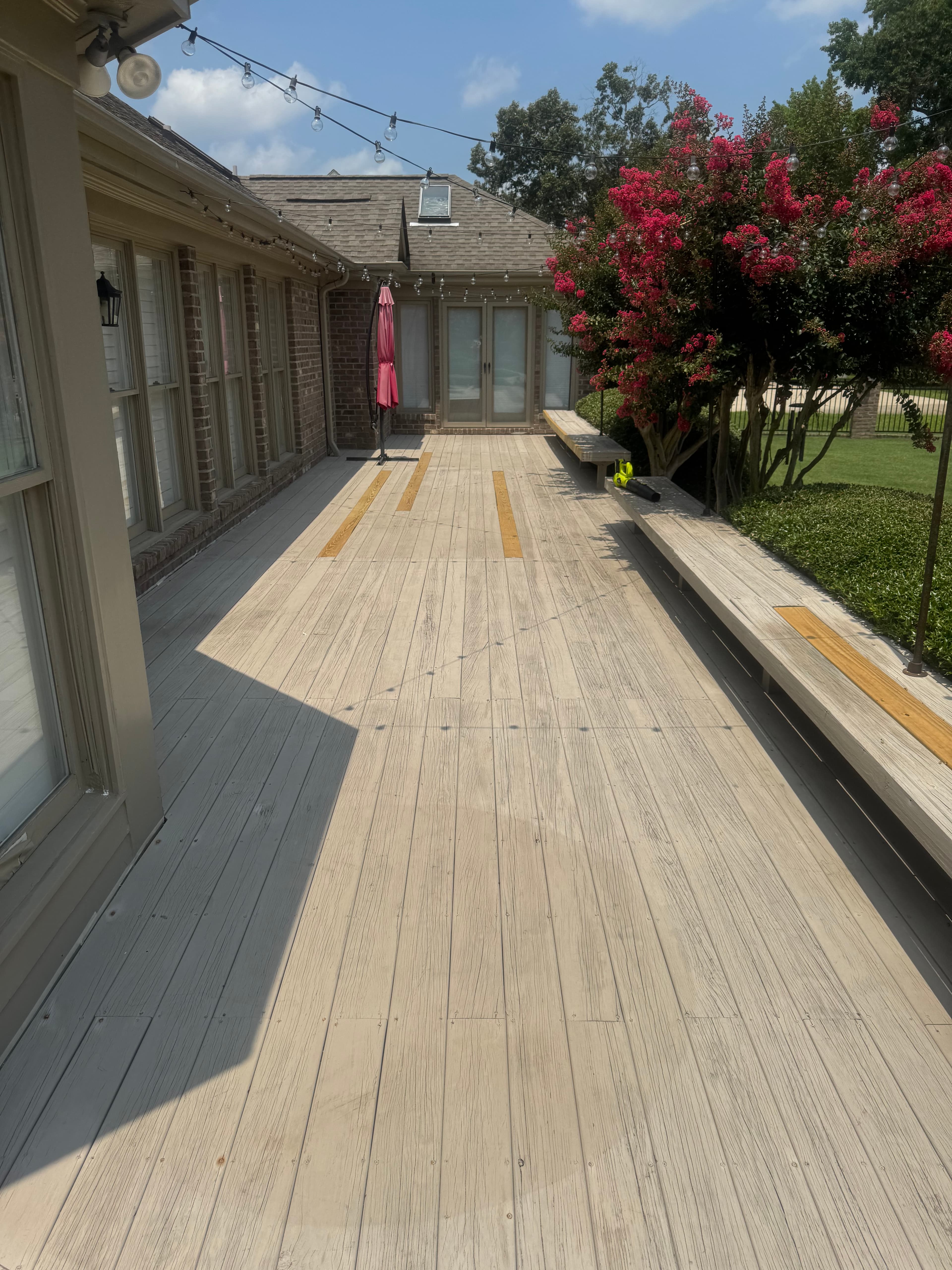 Wood deck with gray weathered boards and organic buildup in Fayetteville NC before cleaning and staining