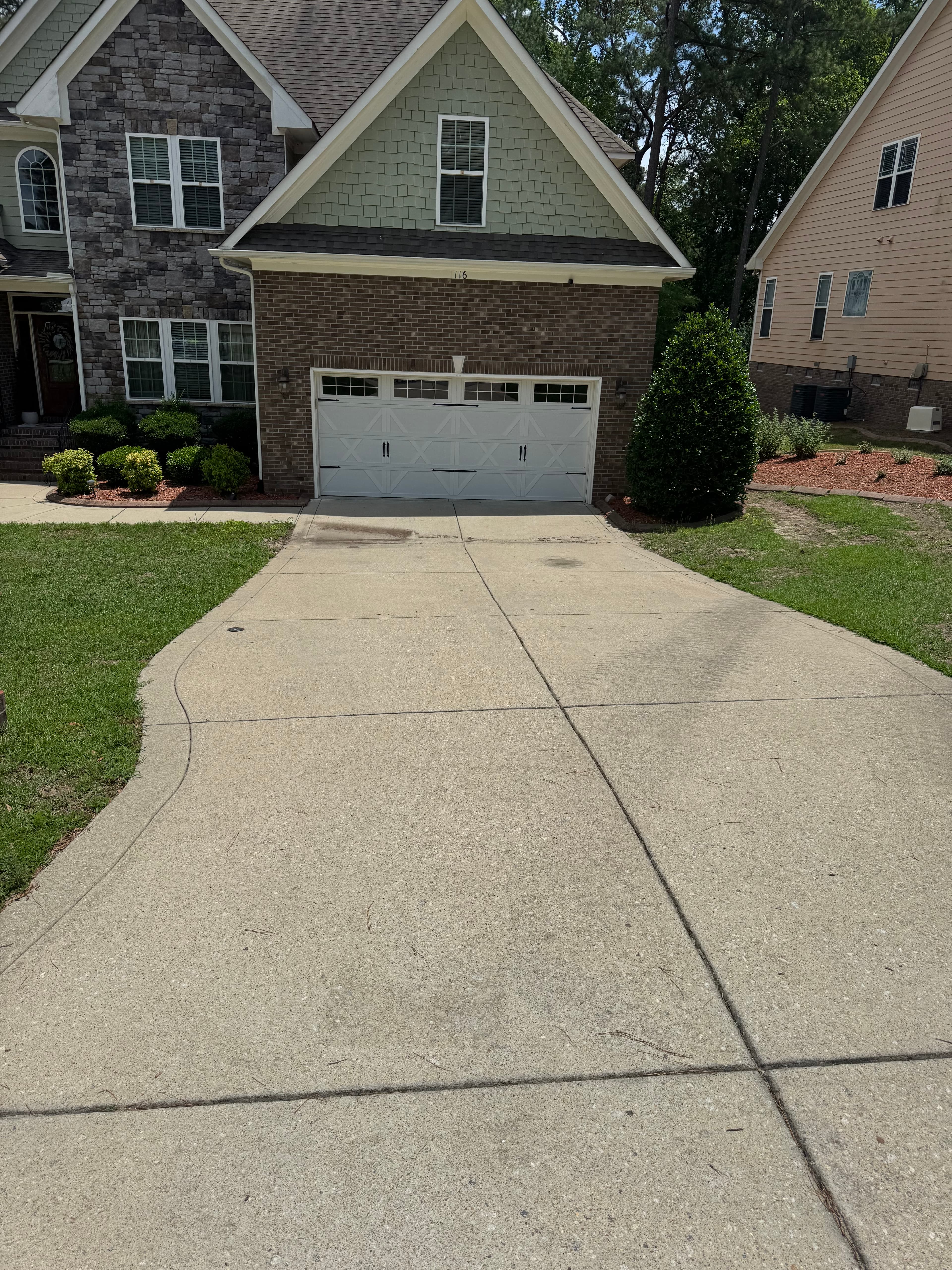 Before driveway cleaning in Fayetteville NC — concrete with heavy staining and grime
