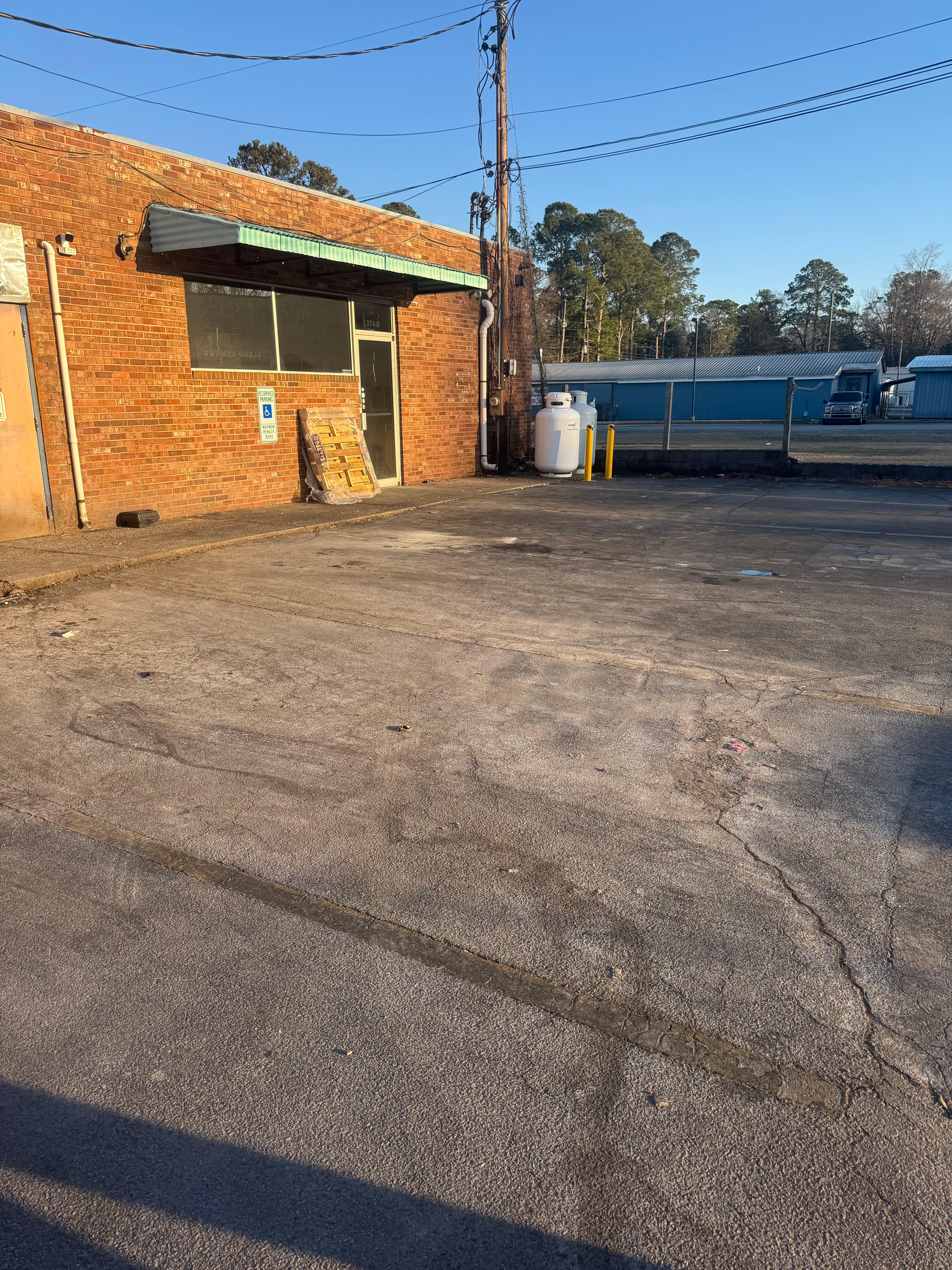 Commercial parking lot with heavy grime and staining in Fayetteville NC before cleaning