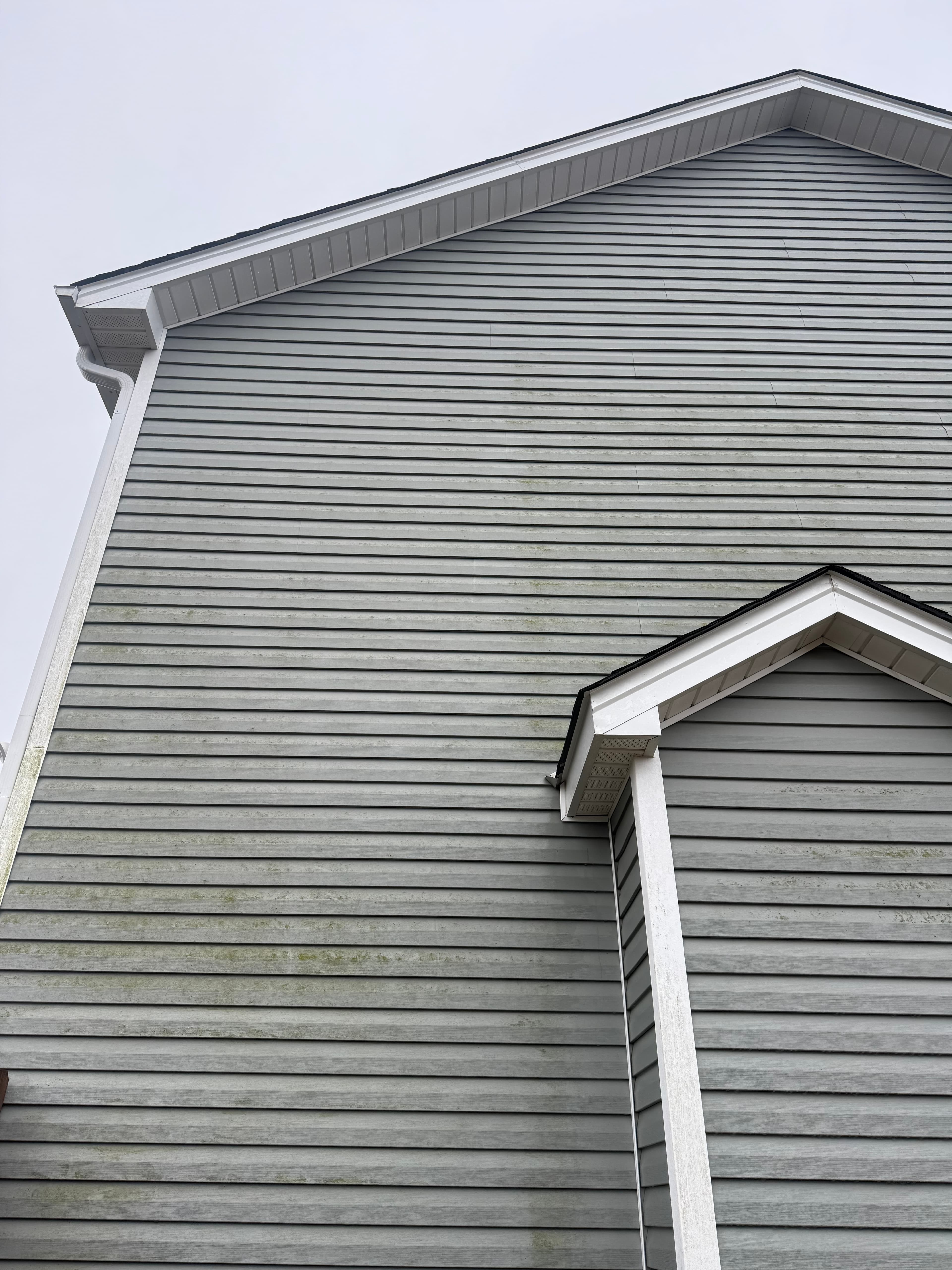 Before vinyl siding house washing in Fayetteville NC — exterior with mold and discoloration