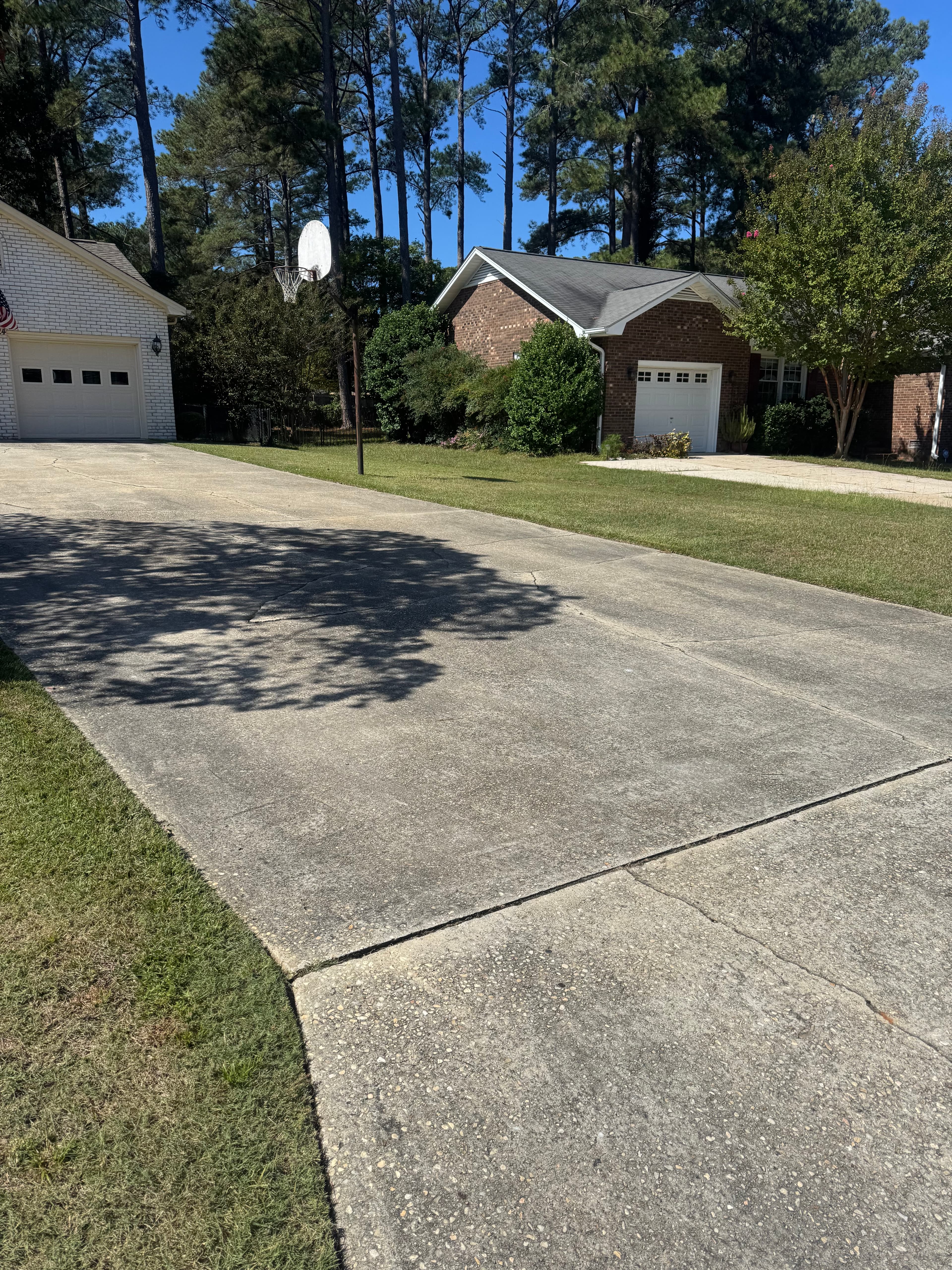 Concrete driveway with oil stains and NC red clay buildup in Fayetteville NC