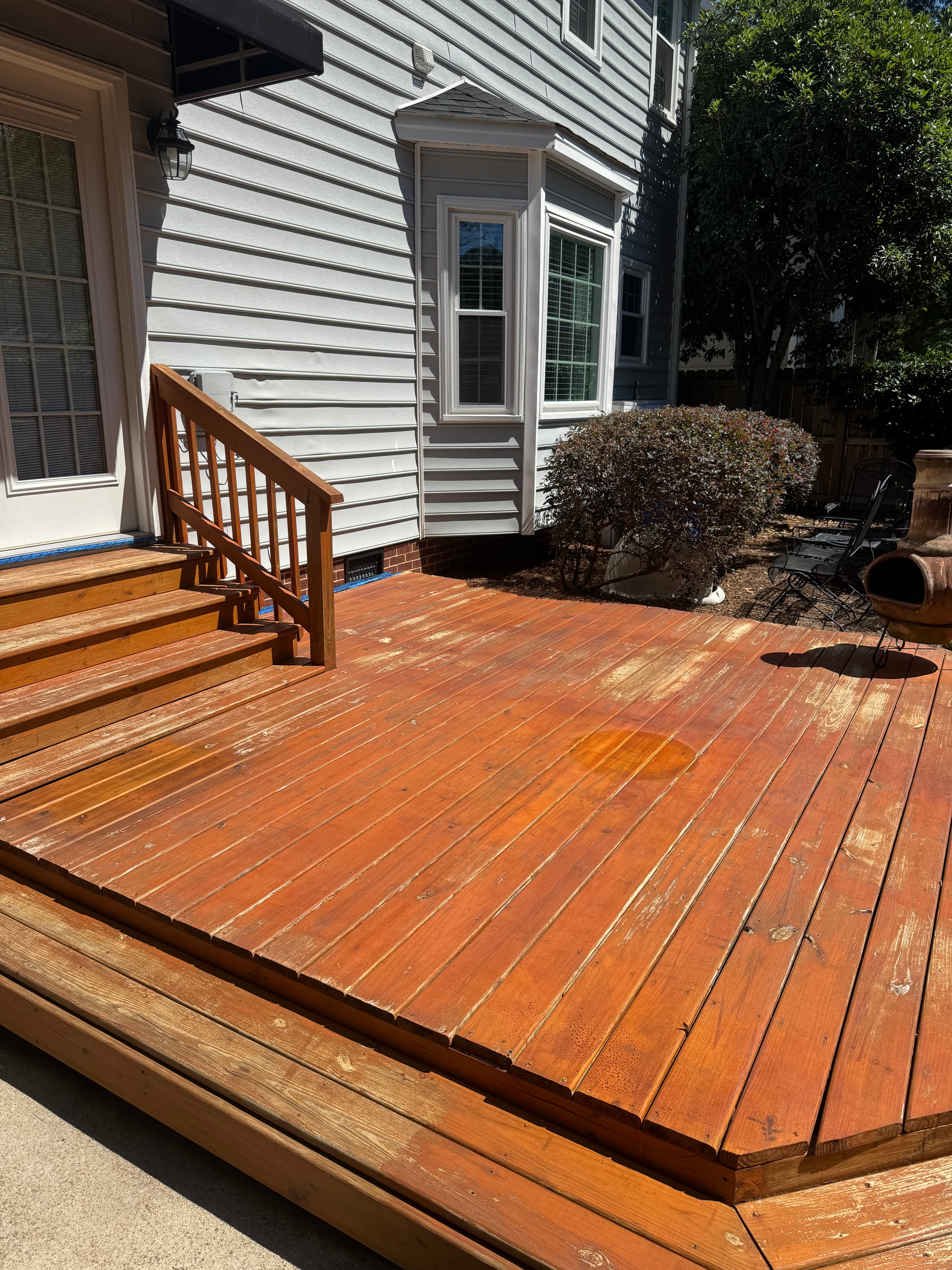 Wood deck with worn, faded boards in Fayetteville NC before staining